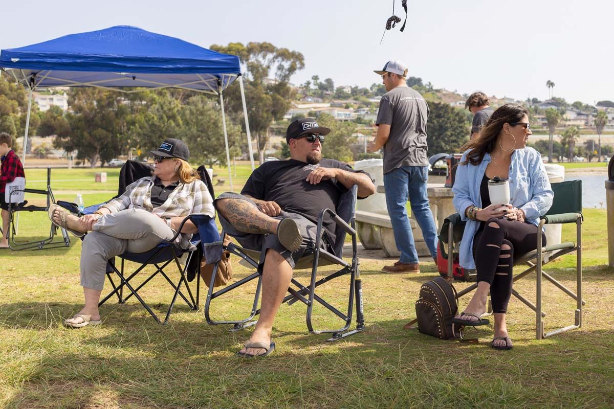 People sitting in park on folding chairs