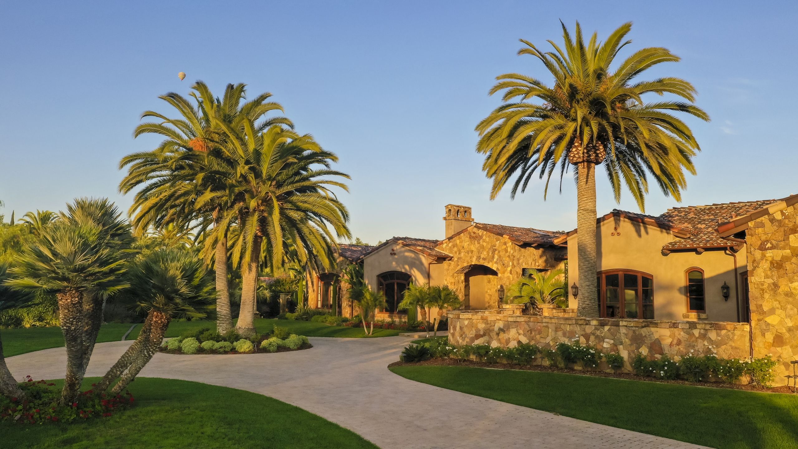 Tropical home, palm trees, stone house